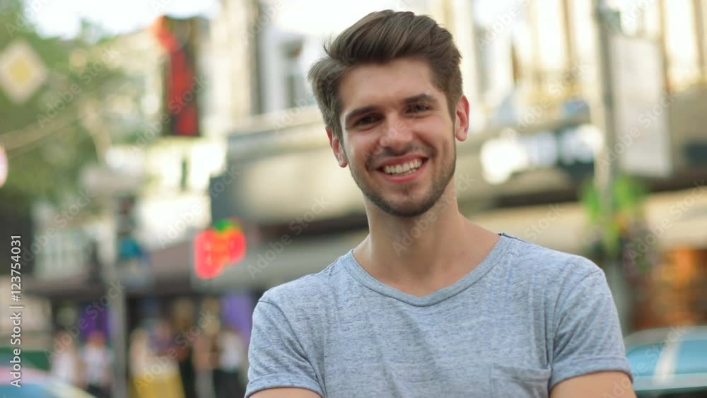Portrait of a handsome smiling man looking at the camera in city Portrait of a handsome smiling man looking at the camera in city