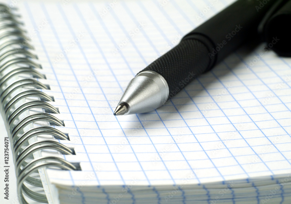 ballpoint pen on open spiral notebook, macro, shallow depth of field ballpoint pen on open spiral notebook, macro, shallow depth of field