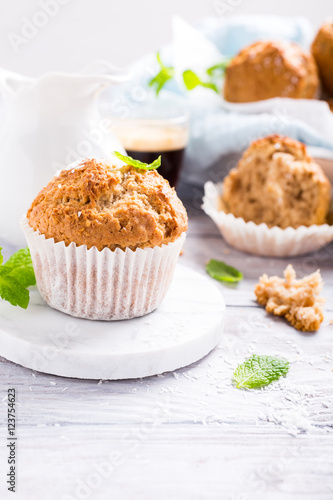 Delicious homemade coconut cinnamon muffin on marble coasters. Healthy food concept with copy space.