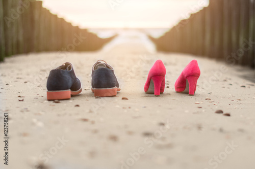 Wedding shoes at the beach in the sand photo