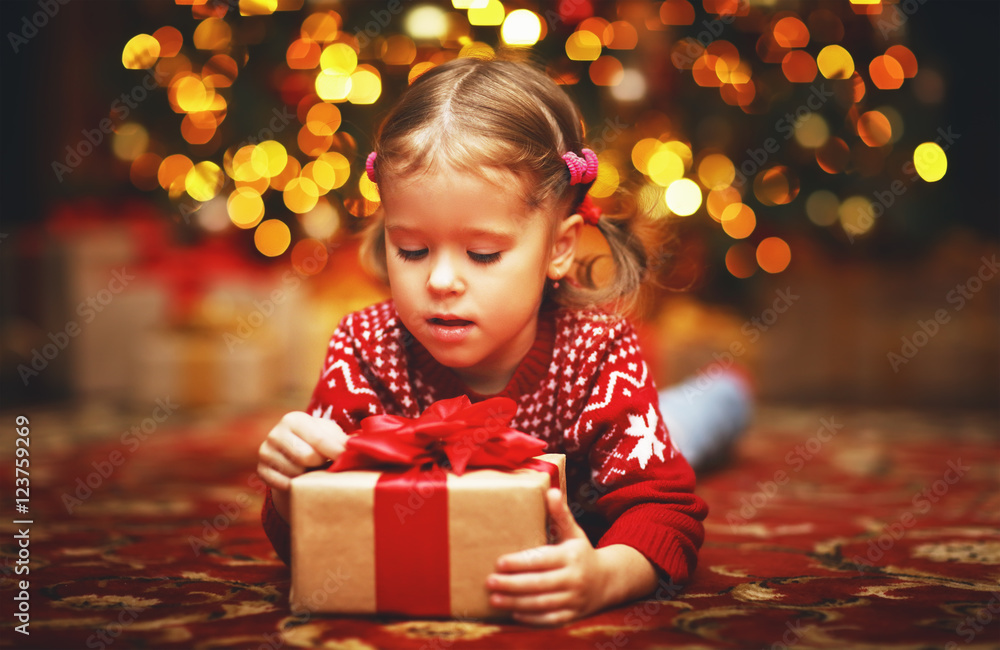 happy child girl with Christmas present happy child girl with Christmas present