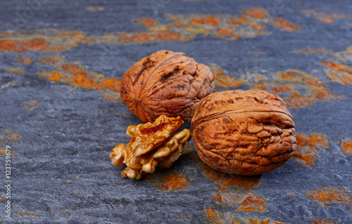 Walnuts on slate background