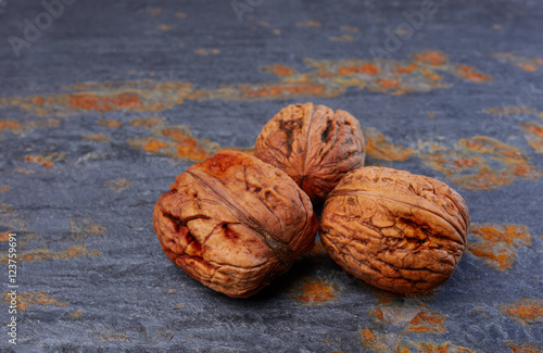 Whole walnuts on slate background