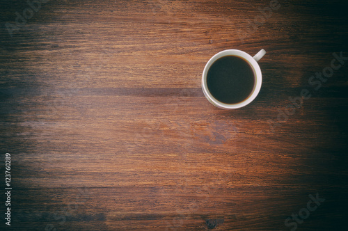 Coffee cup on brown table. Top view
