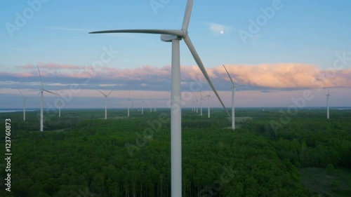 Aerial Shot of Wind Power Plant with Clusters of Wind Turbines Surrounded by Forrest.