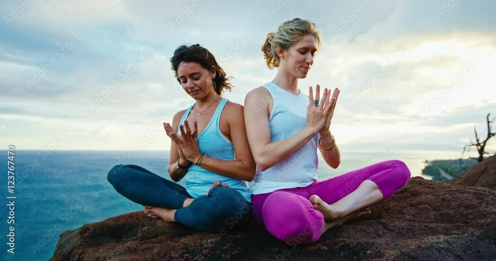 Young women practicing yoga in nature in slow motion