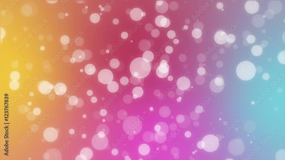 Colorful rainbow abstract holiday background with white bokeh lights flickering on yellow pink blue gradient backdrop. Colorful rainbow abstract holiday background with white bokeh lights flickering on yellow pink blue gradient backdrop.