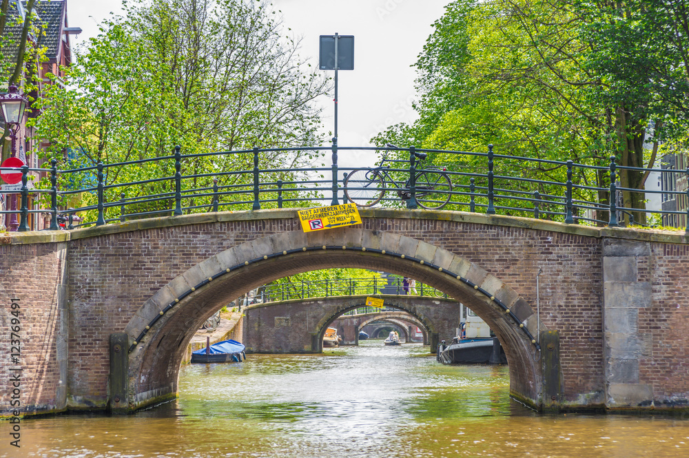 Fototapeta premium Bridge across Amsterdam channel, Netherlands.