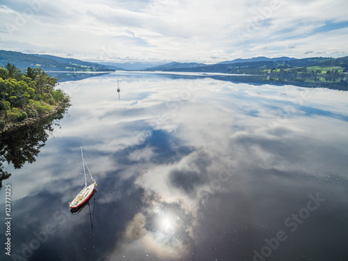 Moored sailboats on Huon River, Huon Valley, Tasmania, Australia. Beautiful aerial image with clouds reflecting in the water photo