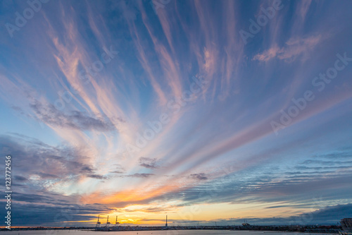 Port cranes silhouettes in beautiful golden glowing sunset in Melbourne, Australia photo