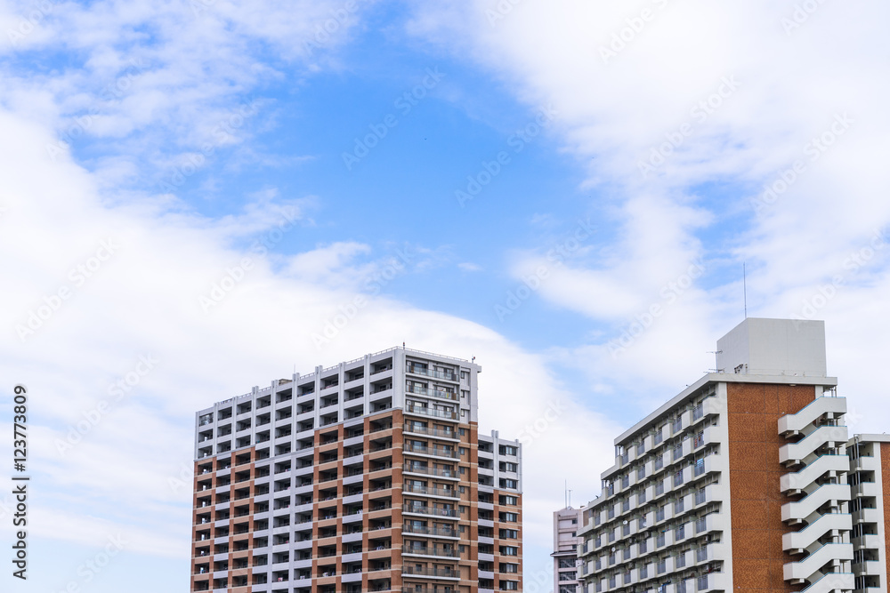 Real estate image, tower apartment building against blue sky Real estate image, tower apartment building against blue sky