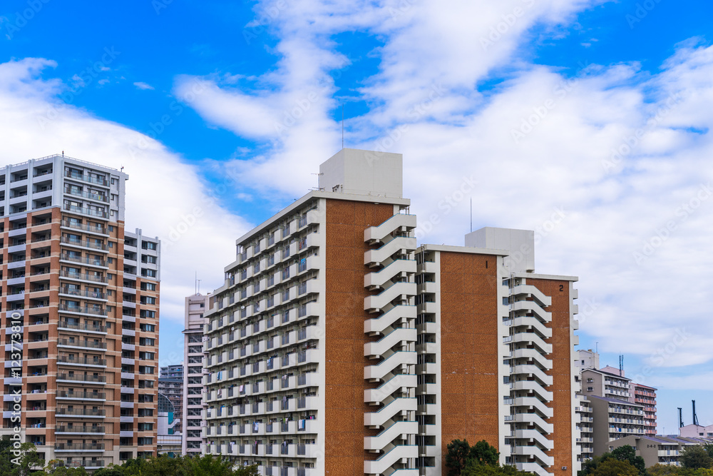 Real estate image, tower apartment building against blue sky