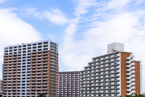 Real estate image, tower apartment building against blue sky