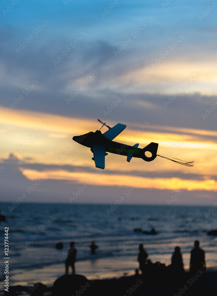 Air plane toy silhoette on the bech with sunset blur background. Air plane toy silhoette on the bech with sunset blur background.