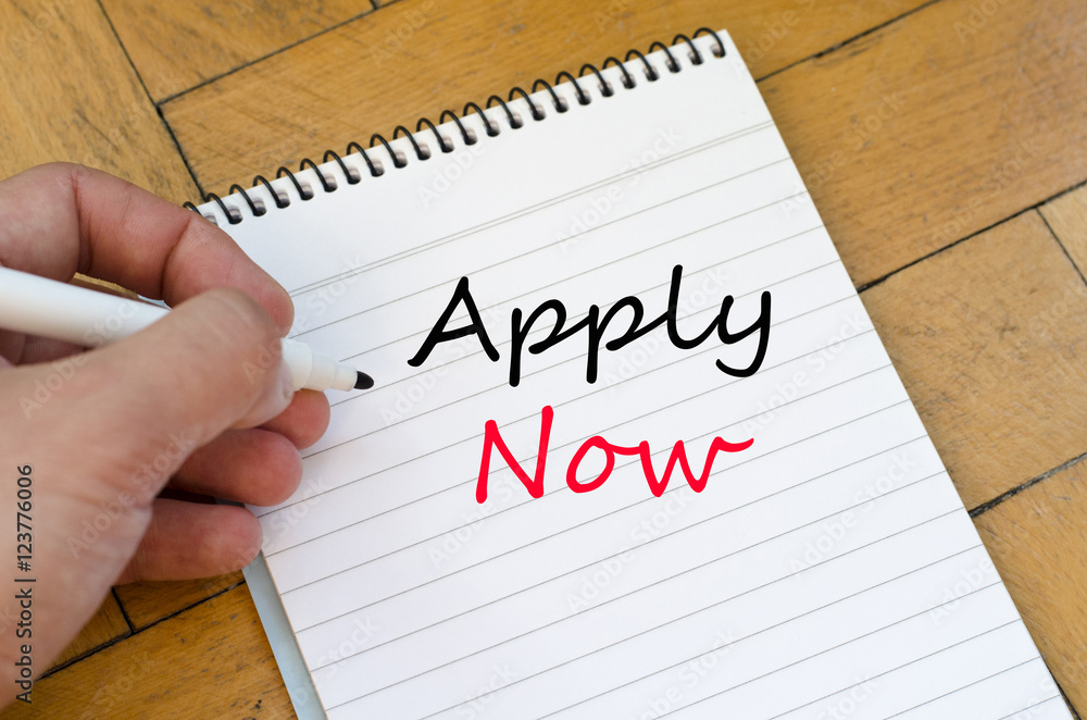 Apply now text concept on notebook Apply now text concept on notebook