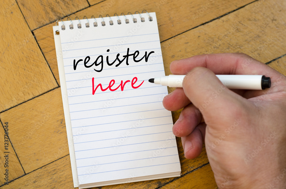 Register here text concept on notebook Register here text concept on notebook