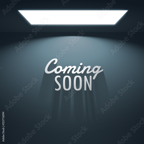 coming soon text with shadows placed under glowing lamp