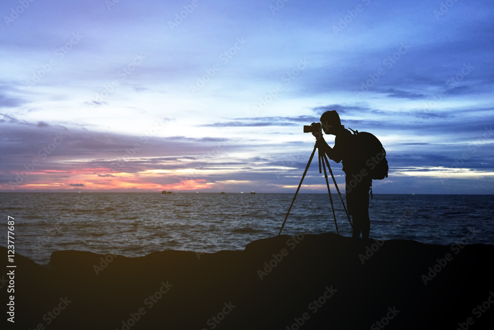 silhouette  of man photography on mountain and sea at sunset