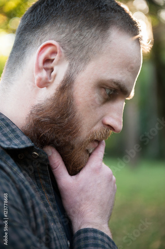 thoughtful young man with a beard
