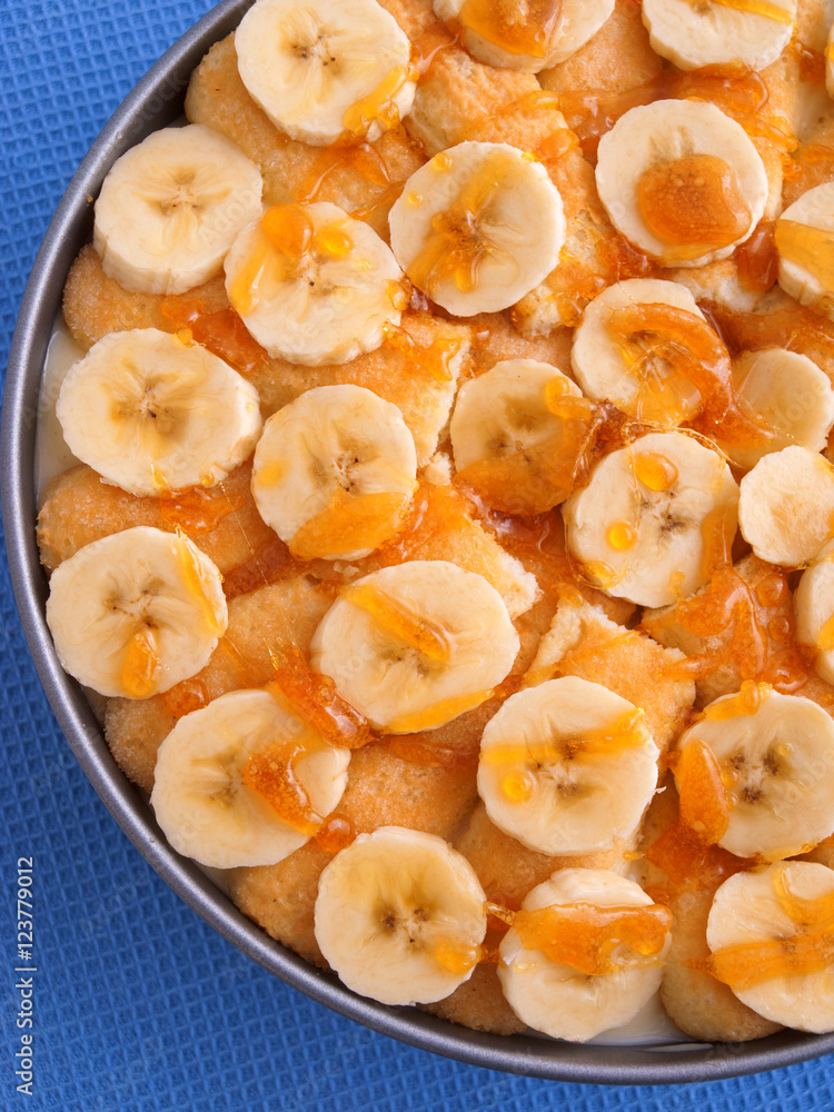 Homemade cake with bananas and caramel in a bowl. Vertical shot Homemade cake with bananas and caramel in a bowl. Vertical shot
