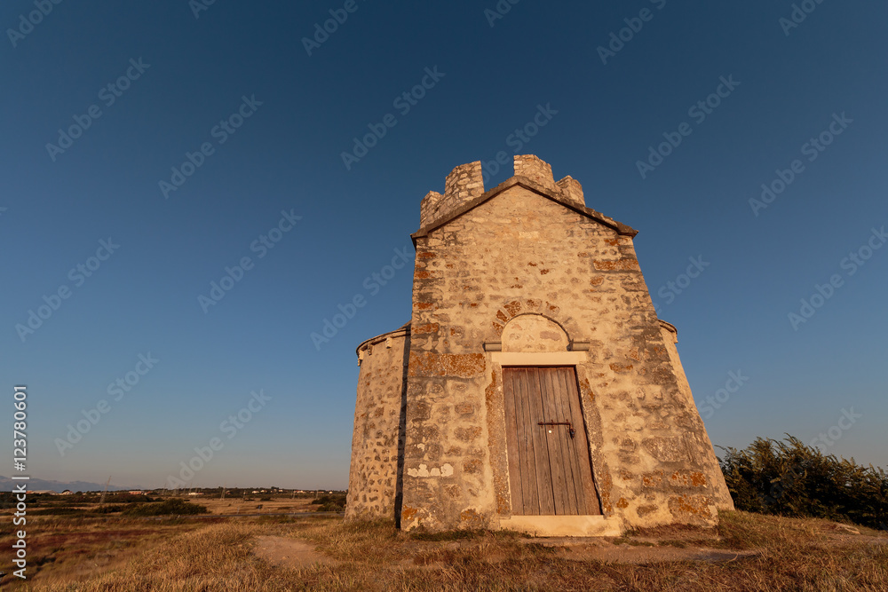 Old small stone church of St. Nicholas on hill near city of Nin in Croatia. Golden hour. Old small stone church of St. Nicholas on hill near city of Nin in Croatia. Golden hour.