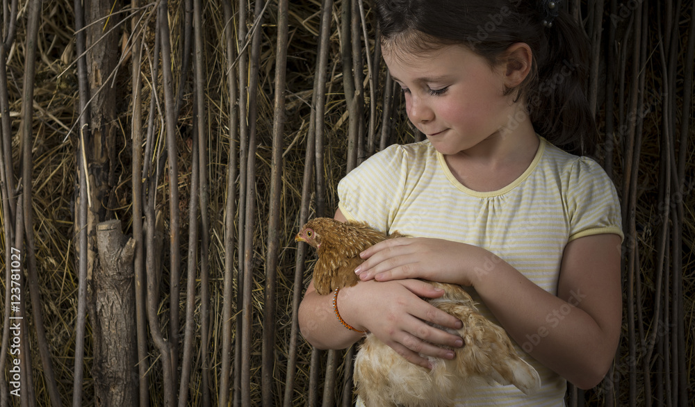 Countryside girl holding a chick