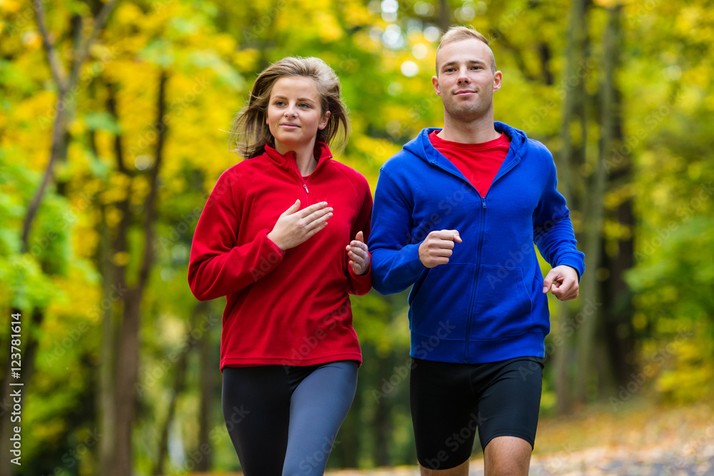 Woman and man running in park Woman and man running in park