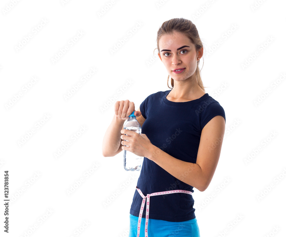 Woman with centimeter opening a bottle of water Woman with centimeter opening a bottle of water
