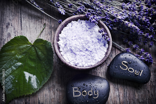 Tableau sur toile Wellness of body and soul with lavender, spa salt, stones and a green leaf