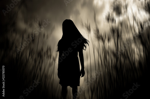 Girl walking in the woods,Horror Background For Halloween Concept And Movie Poster Project