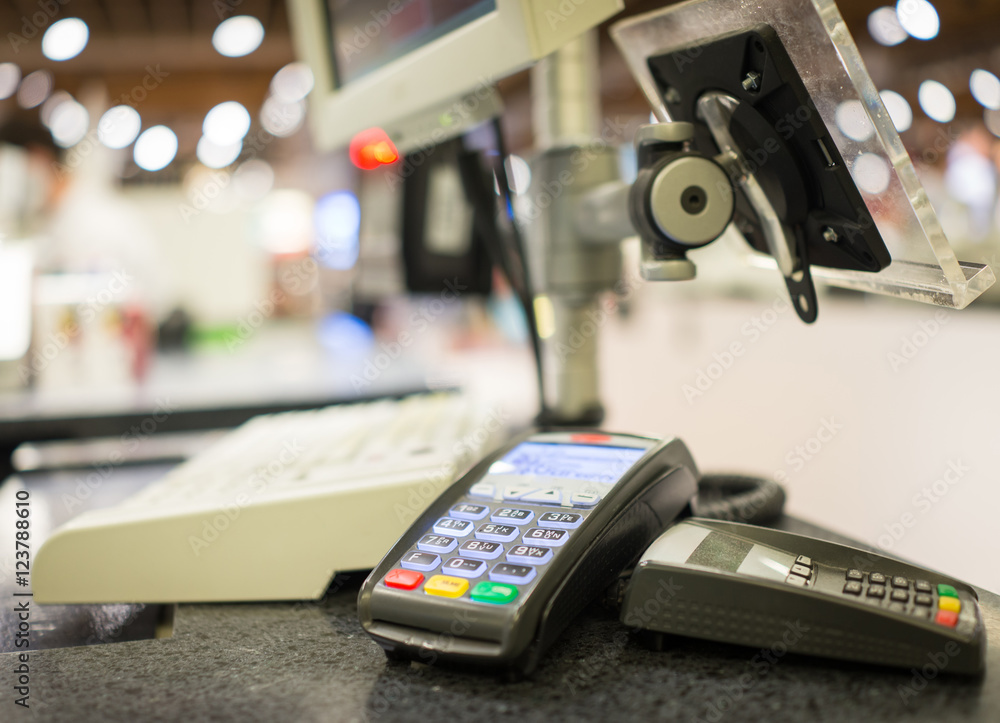Hand Swiping Credit Card on POS terminal in Store Hand Swiping Credit Card on POS terminal in Store