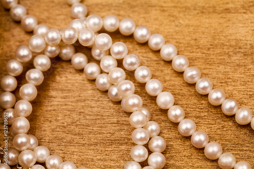 Pearls on a wooden surface