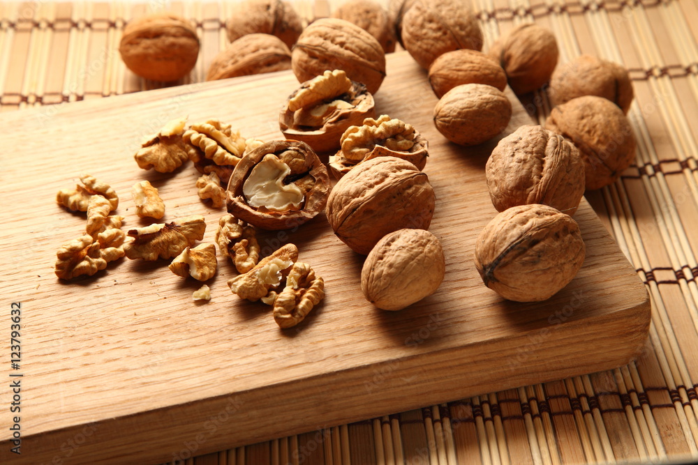 Walnut on a cutting board made of oak/ Walnut on a cutting board made of oak Walnut on a cutting board made of oak/ Walnut on a cutting board made of oak