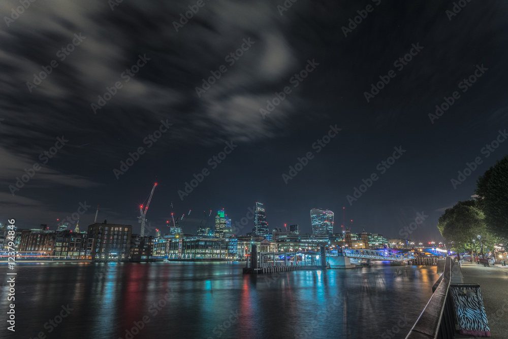 Night skyline of London City from the Millennium bridge, London, United Kingdom