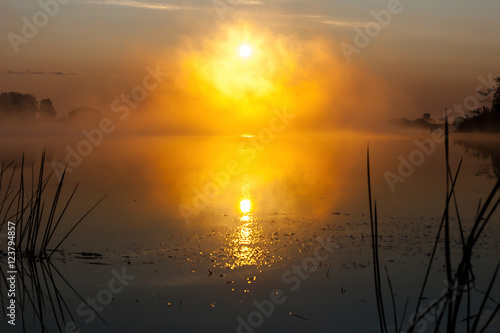 Dawn on the river in the Russian sun in the fog