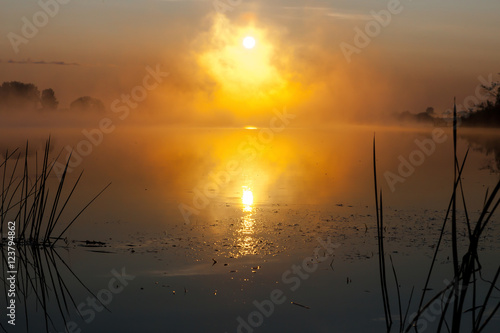 Dawn on the river in the Russian sun in the fog