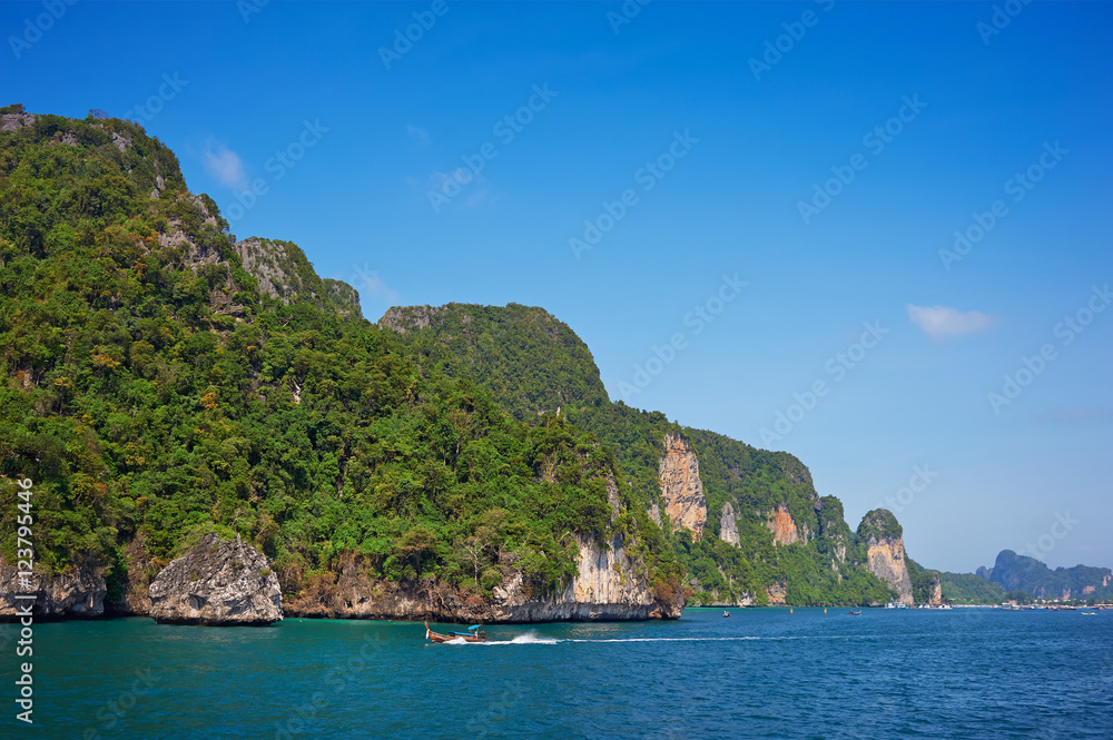 Cliff and the clear sea with long-tail near Phi Phi island in south of Thailand