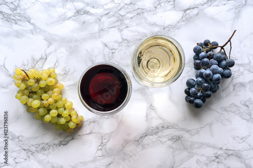 Wine in a wineglass on marble table. Red and white wine. Top view