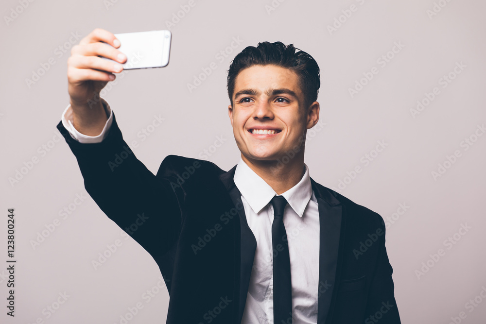 Business man taking selfie from phone on white background Business man taking selfie from phone on white background