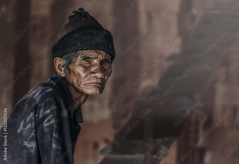 Old senior man closeup serious expression portrait, thinking to his son, unhappy man