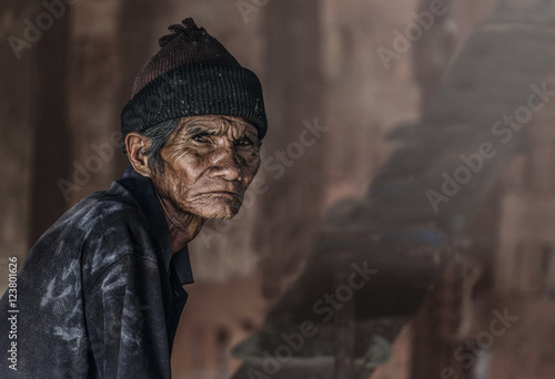 Old senior man closeup serious expression portrait, thinking to his son, unhappy man