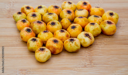 hawthorn fruit on a wooden board