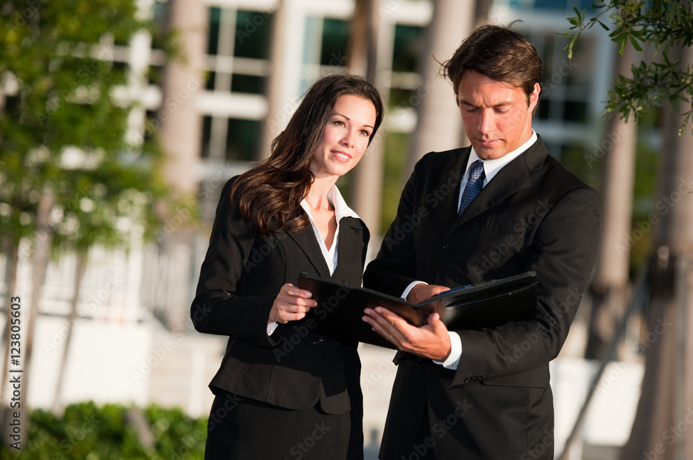 Businessman and Businesswoman downtown outdoors Businessman and Businesswoman downtown outdoors