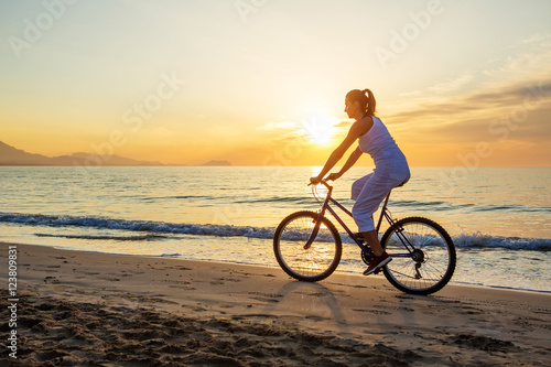  woman on vacation biking at beach © Maygutyak