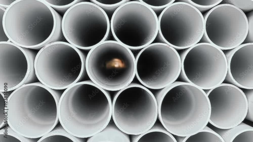 PVC pipes stacked in warehouse. PVC pipes stacked in warehouse.
