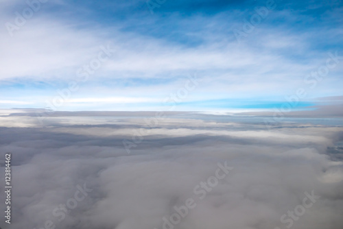 The blue sky against the background of cloud stream. View from the plane. Wide angle