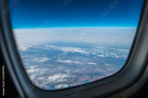 The high altitude on the background of cloud stream. View from the porthole. Wide angle