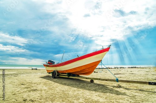 Boat on the beach with ray of light