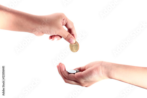 Cropped view of a hand giving a coin to another person
