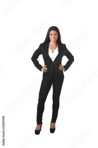 corporate portrait of young attractive latin businesswoman in office suit smiling happy